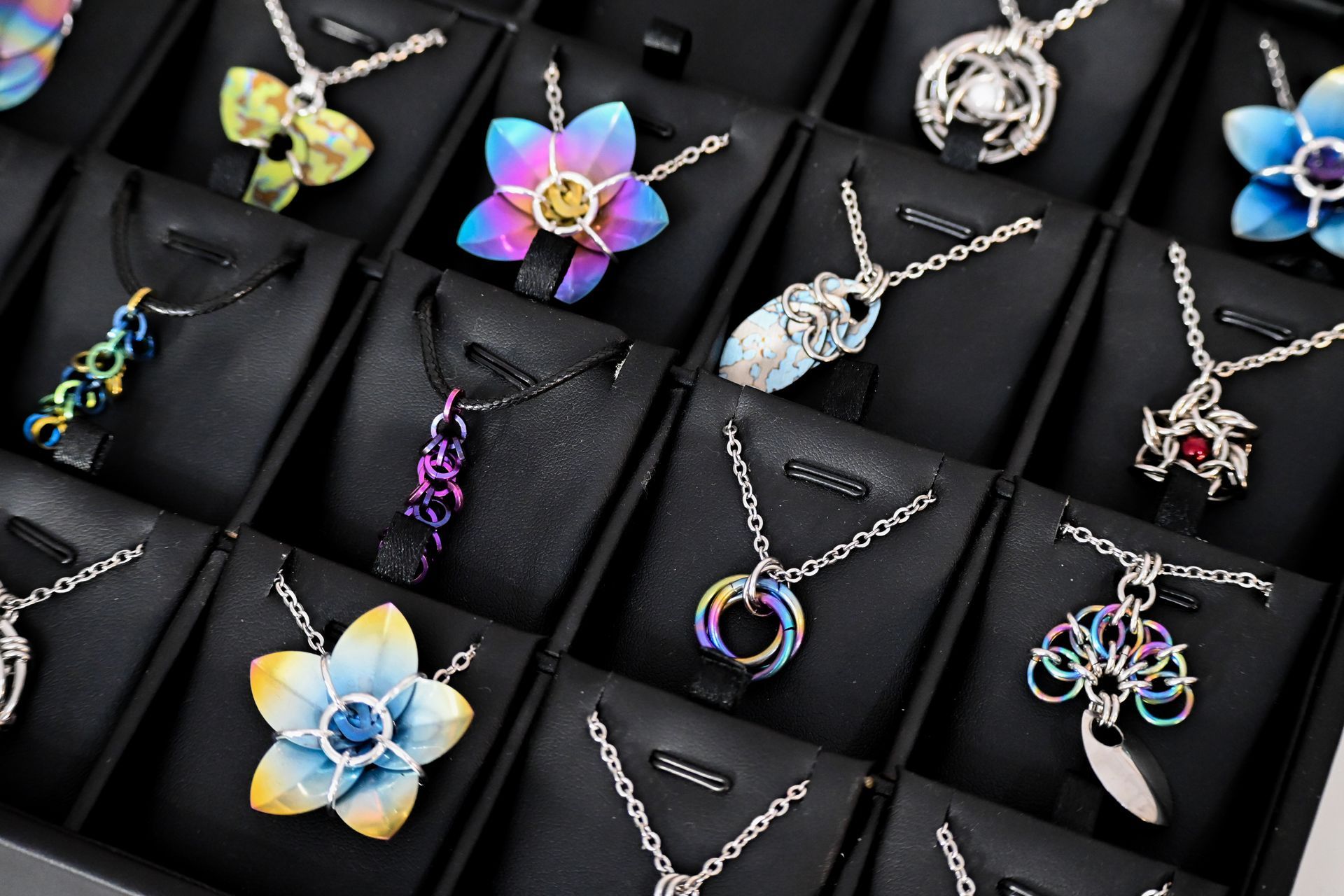 A display case filled with lots of different necklaces.