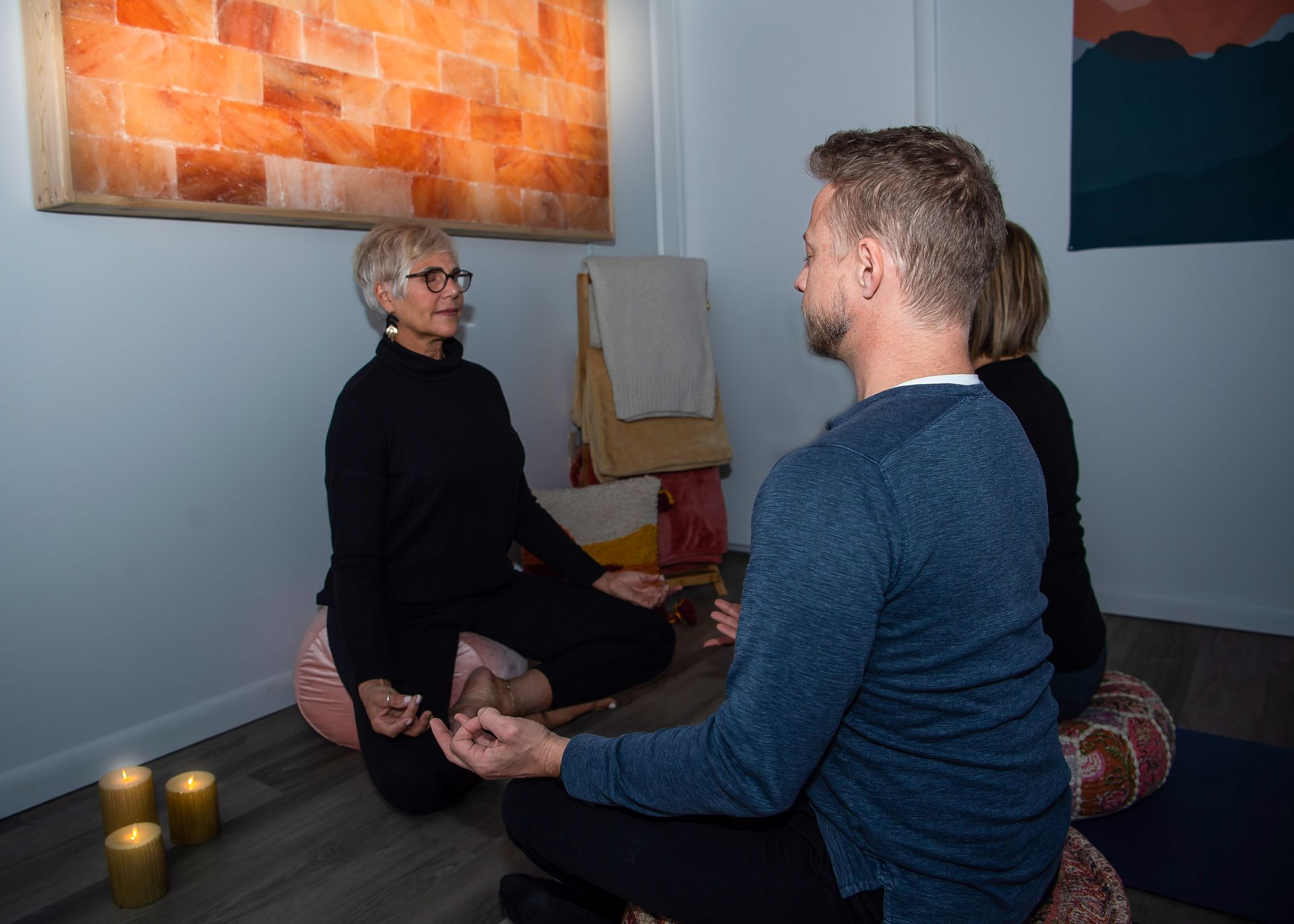 woman meditating while holding incense