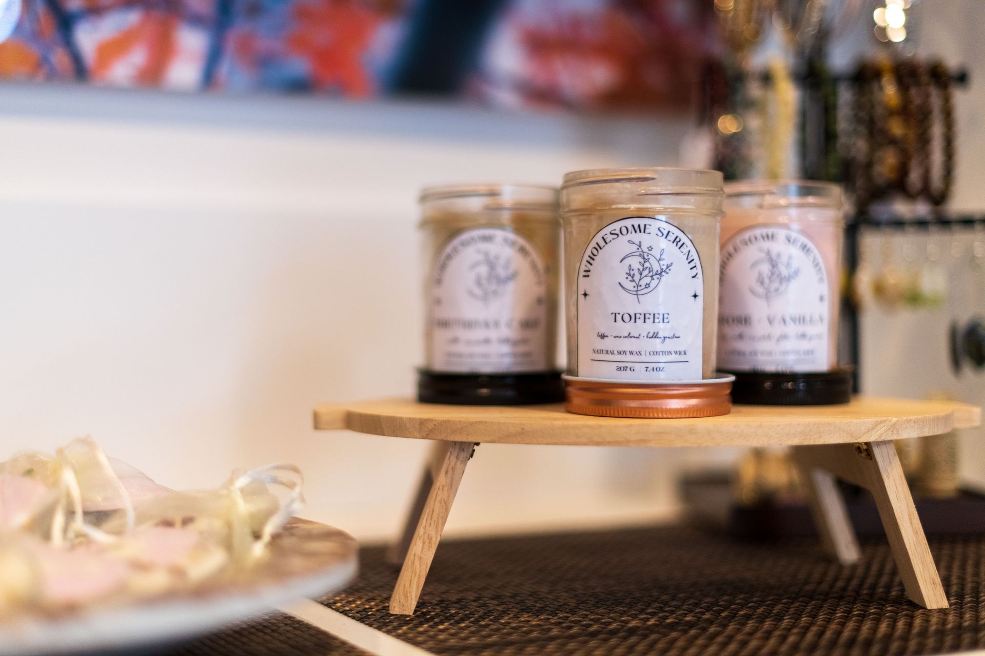 Three candles are sitting on a small wooden table.