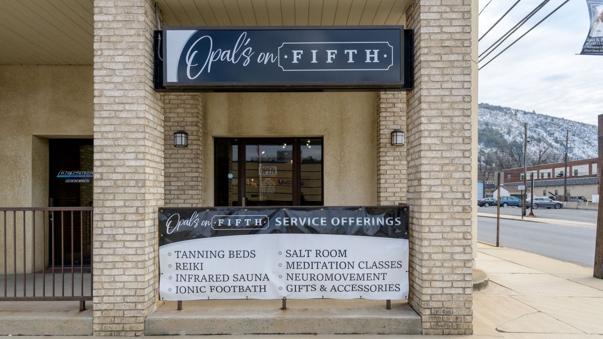 A brick building with a sign that says april 's on fifth