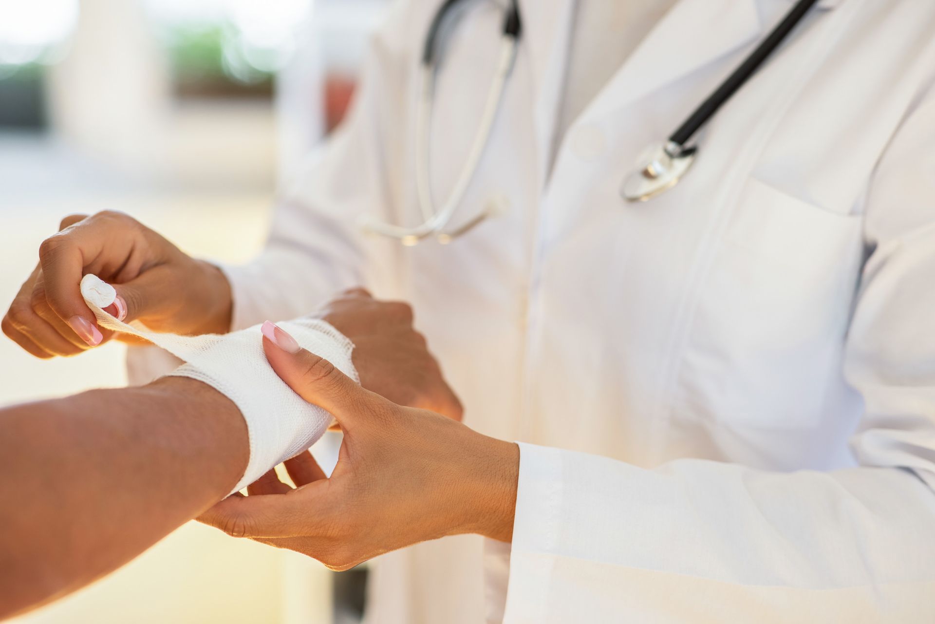 A wound care physician in St. Augustine, FL, carefully bandaging a patient’s arm, demonstrating atte