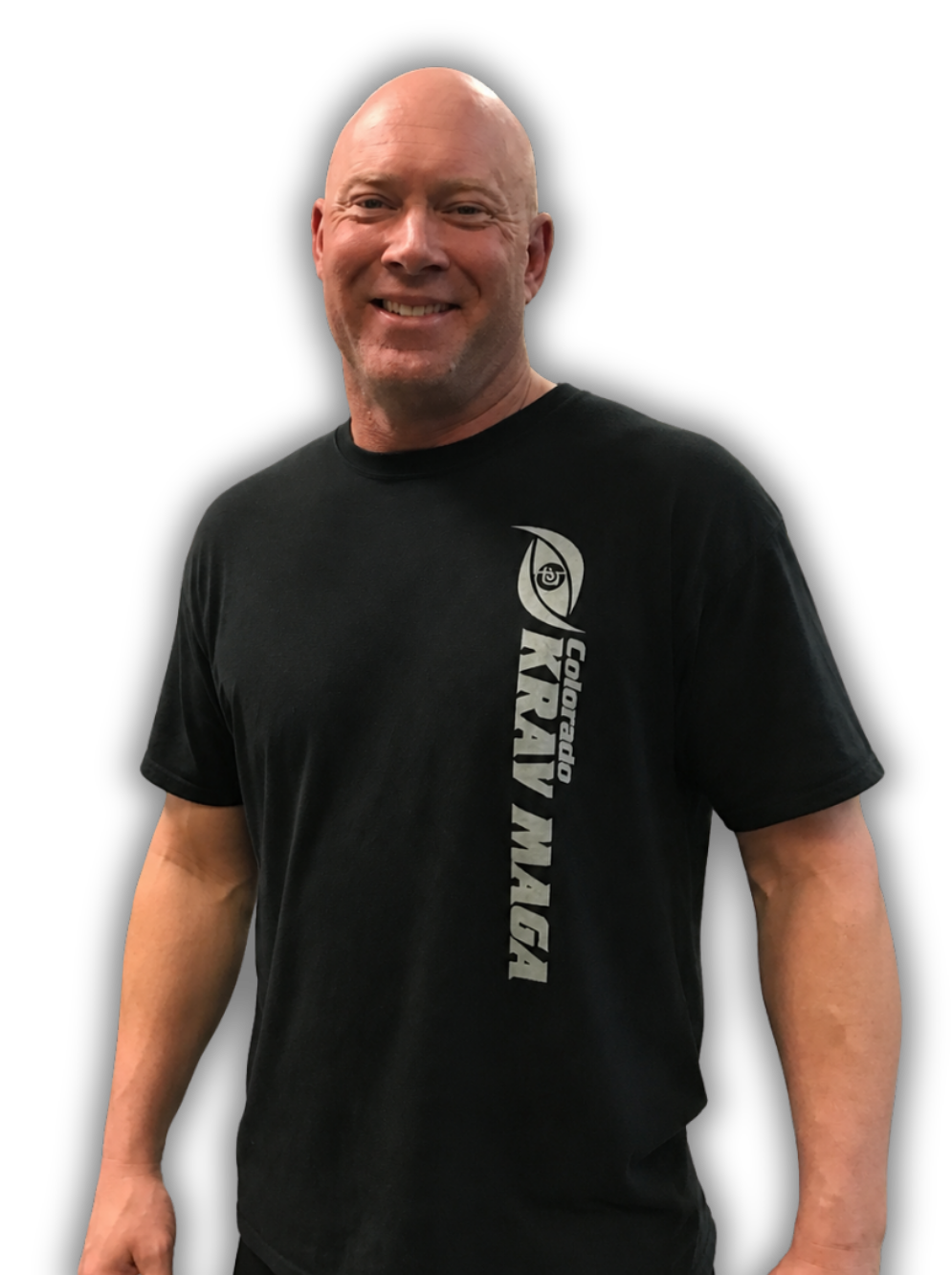 Smiling bald man in a black T-shirt with vertical white logo text, standing against a white background