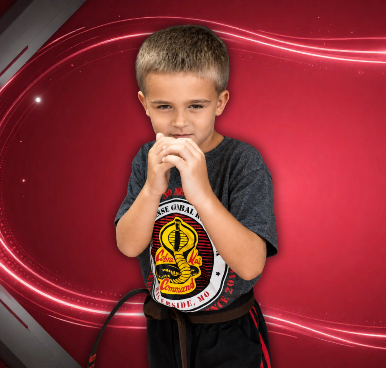 Child standing against a red abstract background, holding hands near mouth with a thoughtful expression.