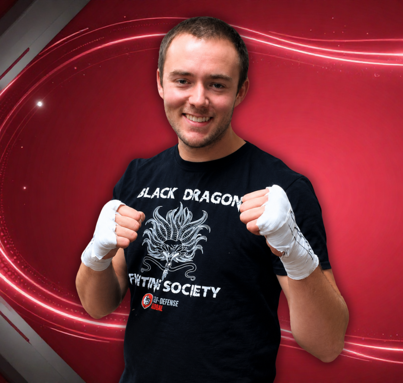 Smiling boxer with wrapped fists posing in front of a red background