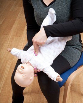 Practising CPR on an Early Years manikin