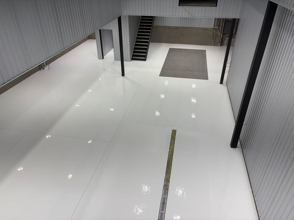 Allée d'entrepôt vide avec des rayonnages de stockage en métal rouge et un sol en béton poli
