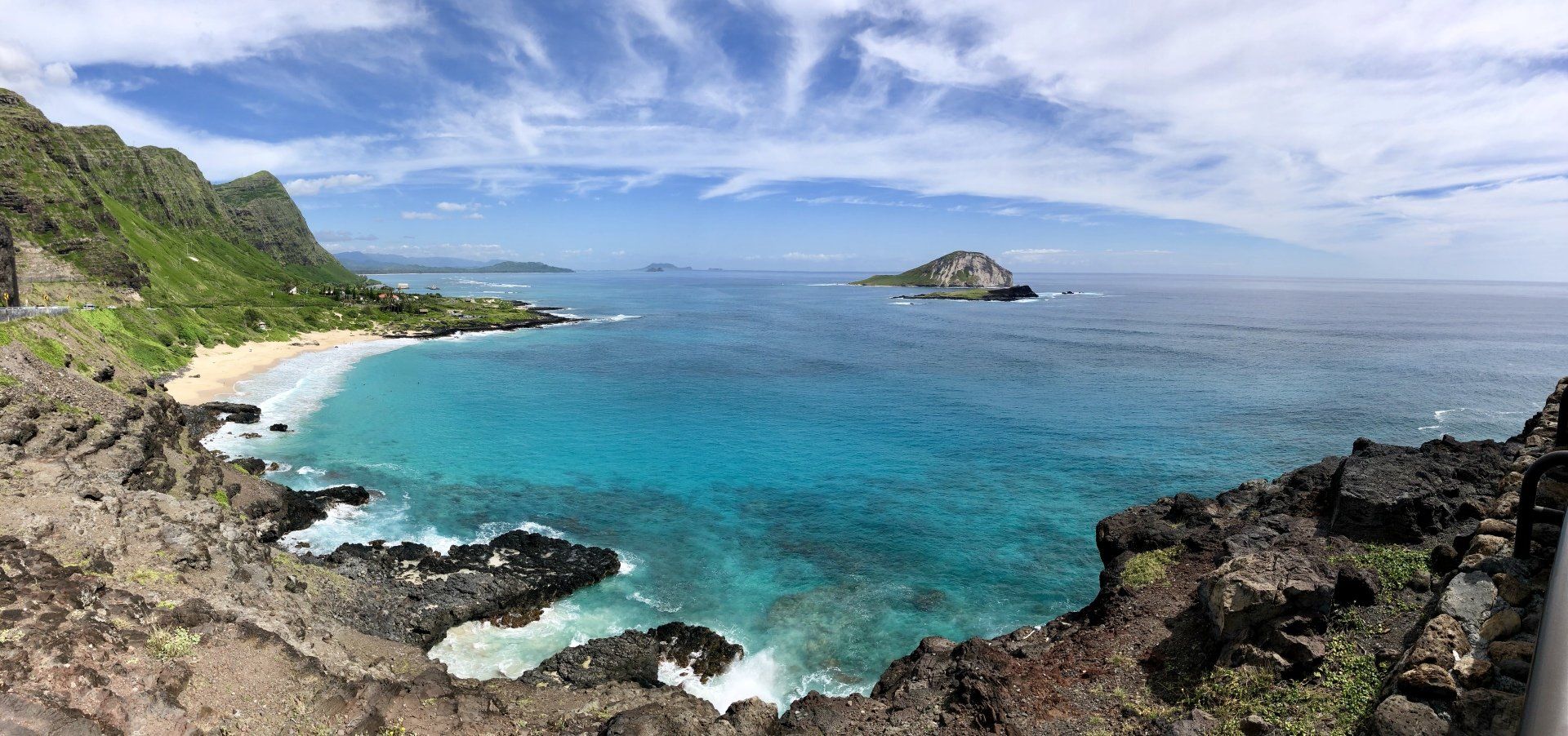 A large body of water surrounded by rocks and mountains.