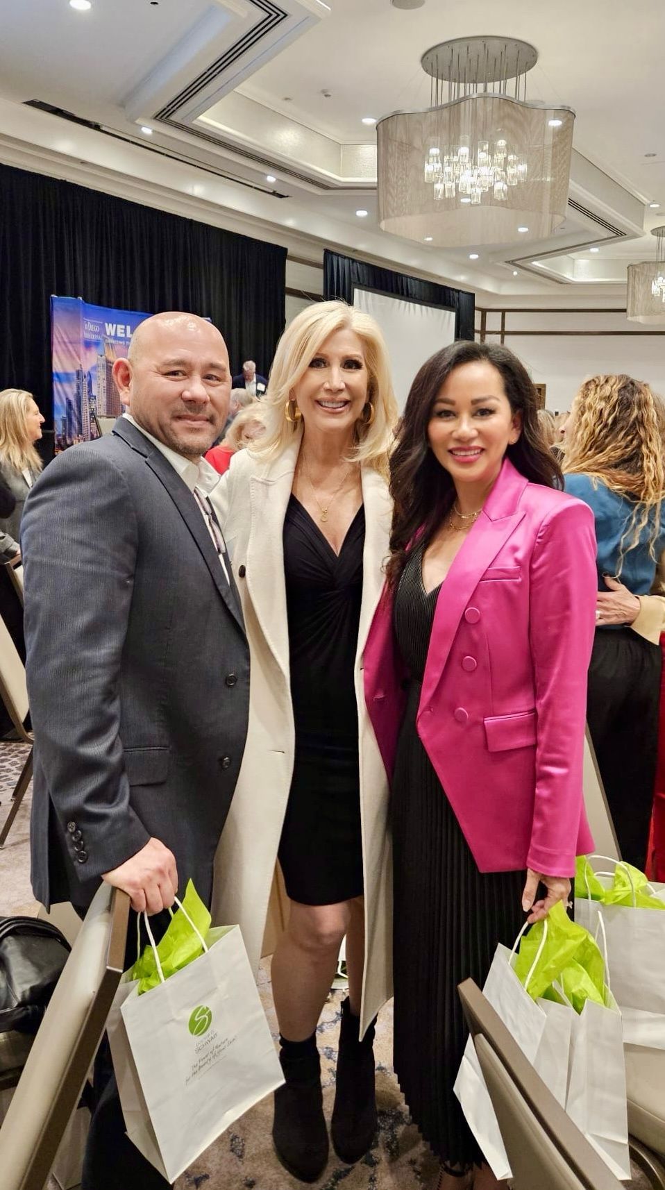 A group of people are posing for a picture at a conference.