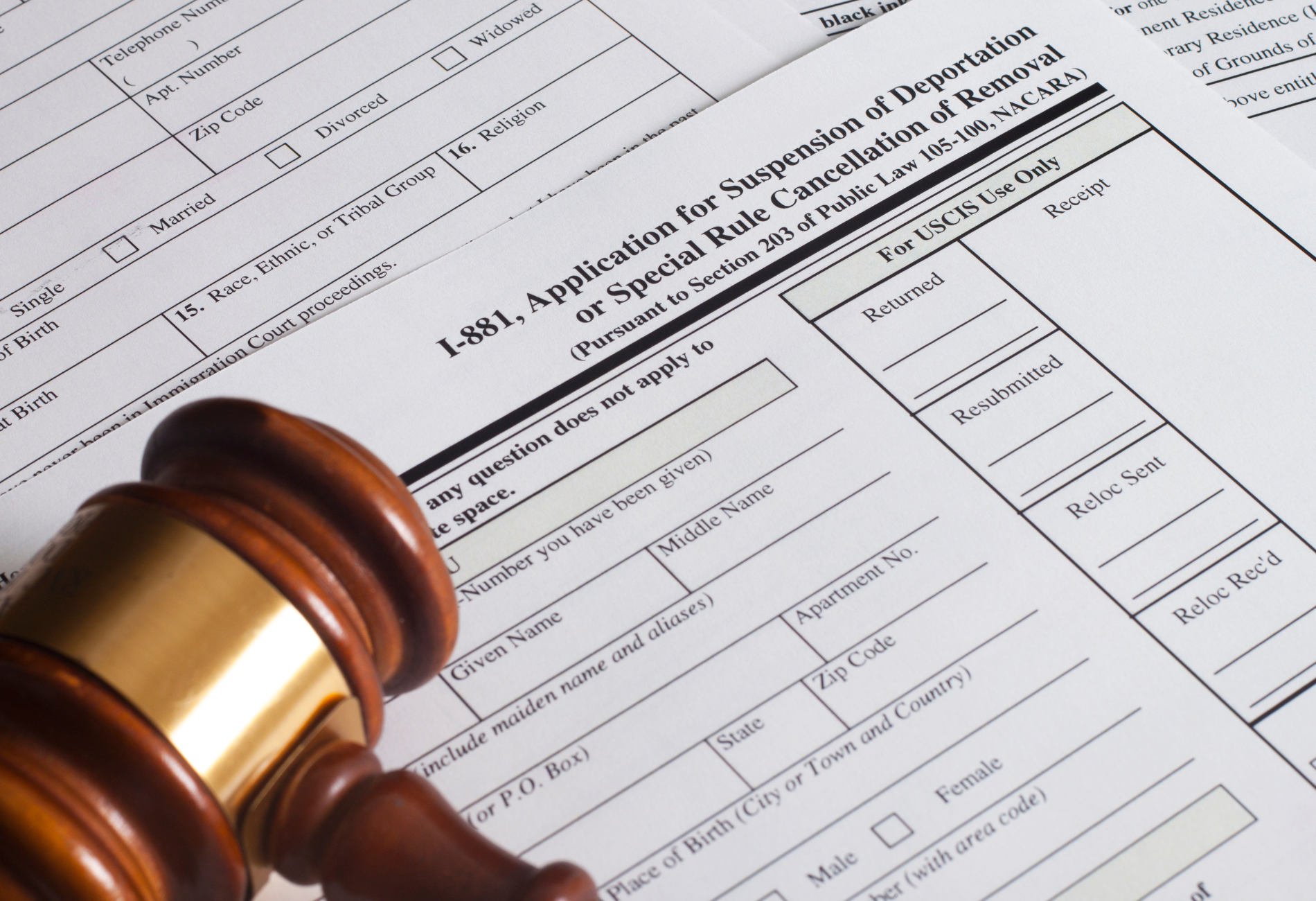 A judge 's gavel and handcuffs are on a table.