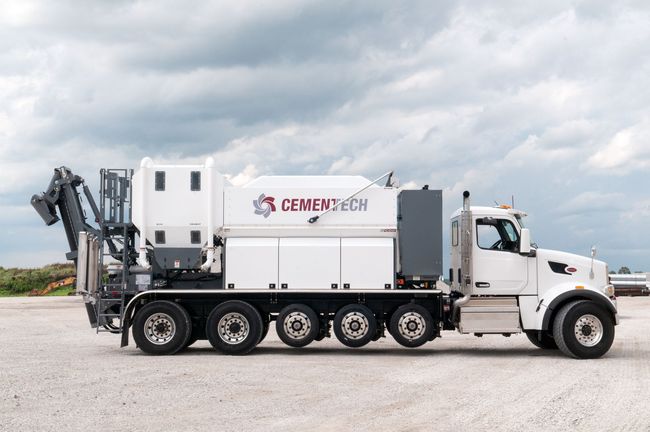 White Cementech truck with Volumetric Mixers on job site. White Cementech truck with Volumetric Mixers on job site.