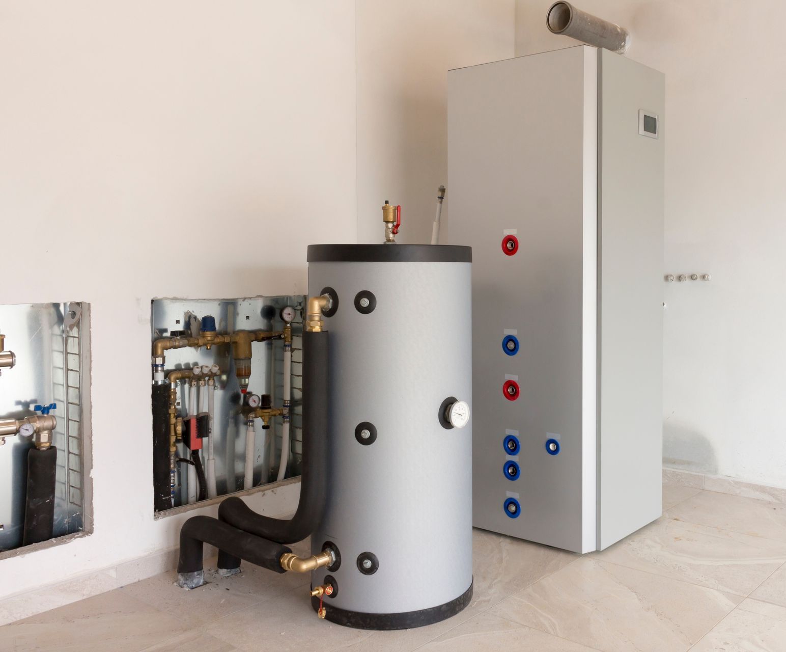 An air-to-water heat pump system installed in a boiler room.