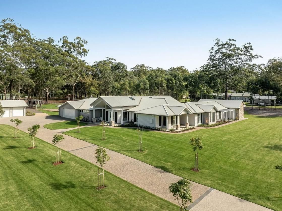 An Aerial View of a Large House Surrounded by Trees and Grass — Windamere Homes in Highfields, QLD