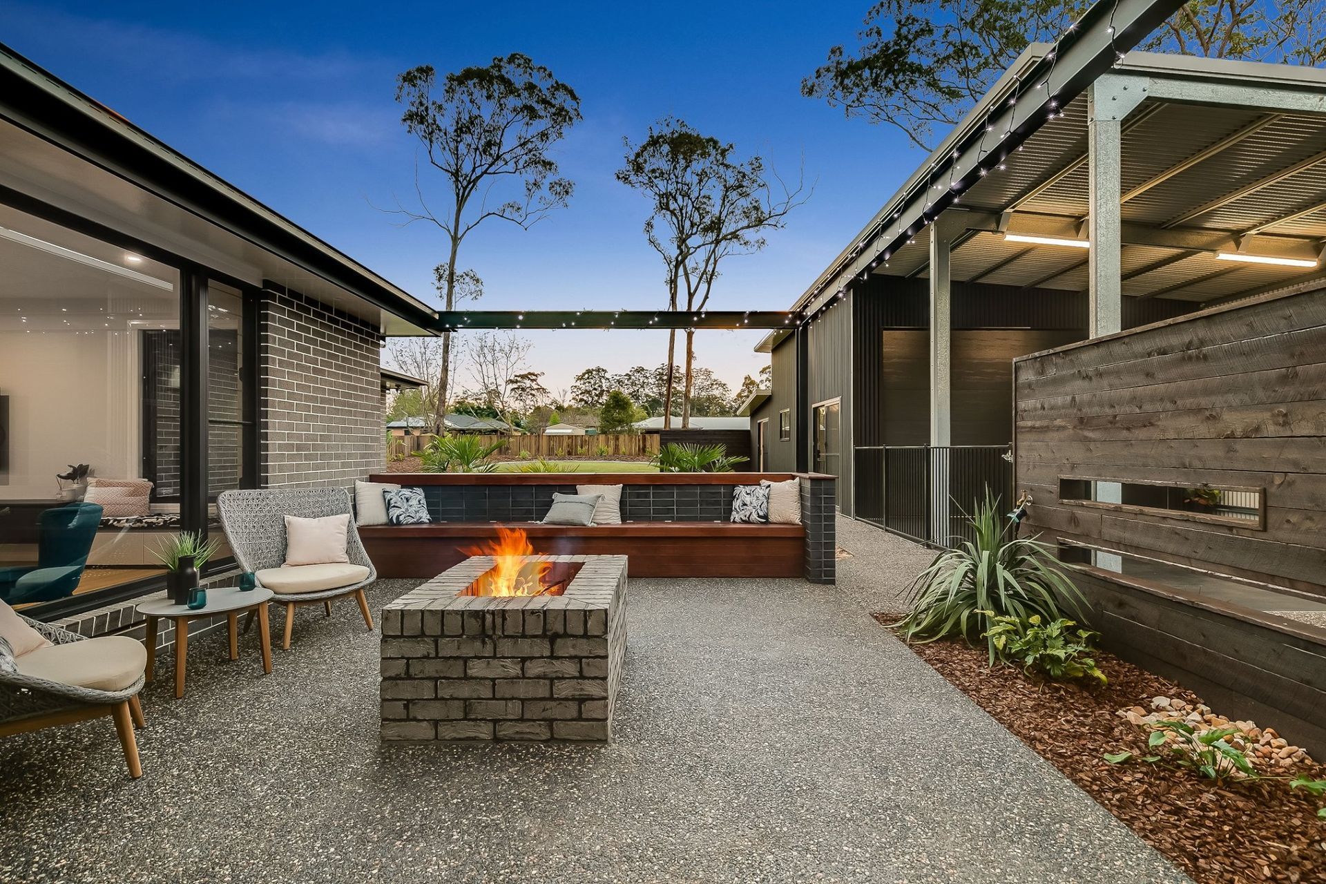 There is a fire pit in the middle of the patio. — Windamere Homes in Highfields, QLD