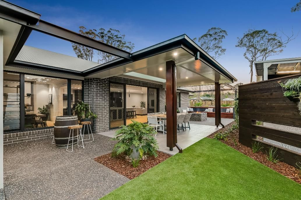 A House With a Covered Patio and a Large Lawn in Front of It — Windamere Homes in Highfields, QLD