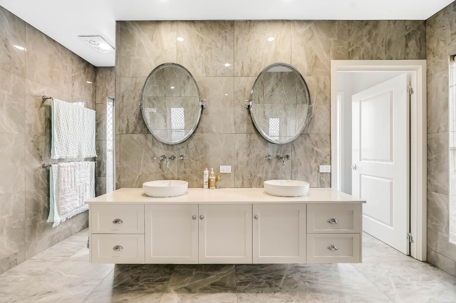 A Bathroom With Sinks and Mirror — Windamere Homes in Highfields, QLD