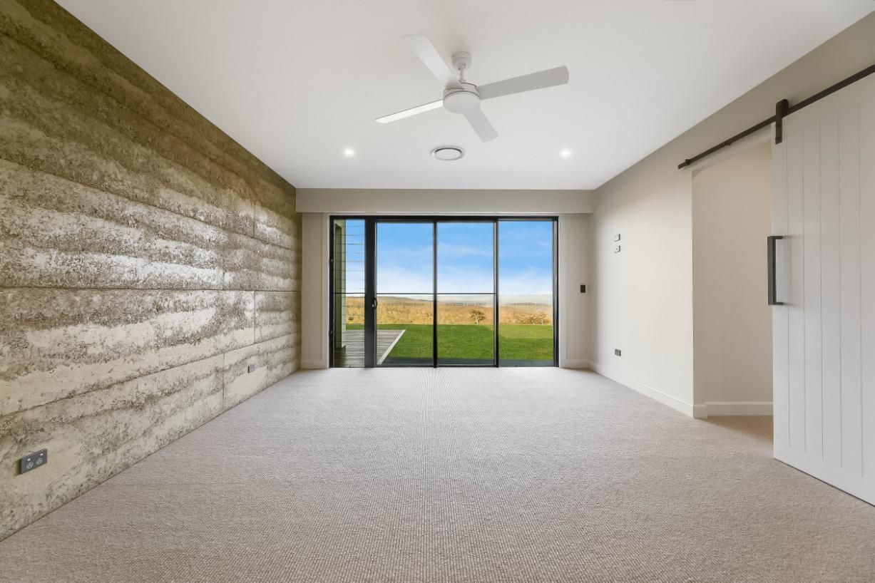 An Empty Room With a Ceiling Fan — Windamere Homes in Highfields, QLD