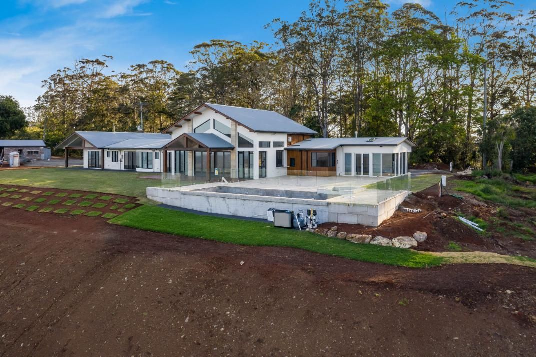A Large House With a Pool With Trees — Windamere Homes in Highfields, QLD