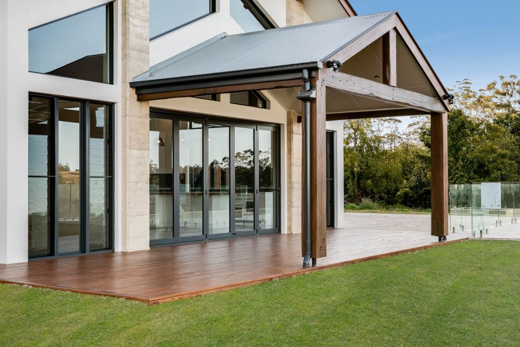 A Large House With a Lot of Windows and a Porch — Windamere Homes in Highfields, QLD
