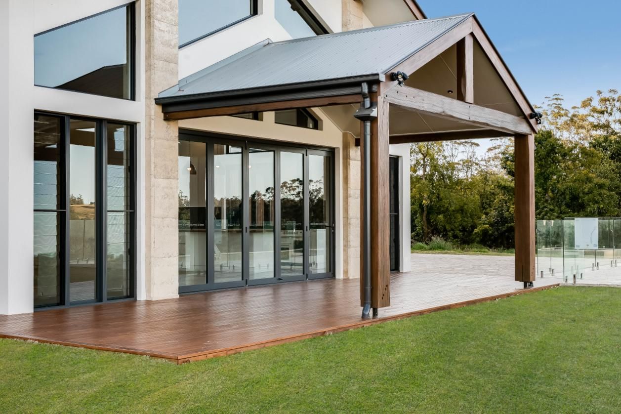 A Large House With a Large Deck and a Covered Porch — Windamere Homes in Highfields, QLD