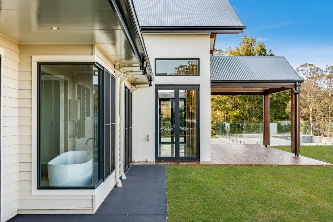 There is a Bathtub in the Bathroom of a House — Windamere Homes in Highfields, QLD