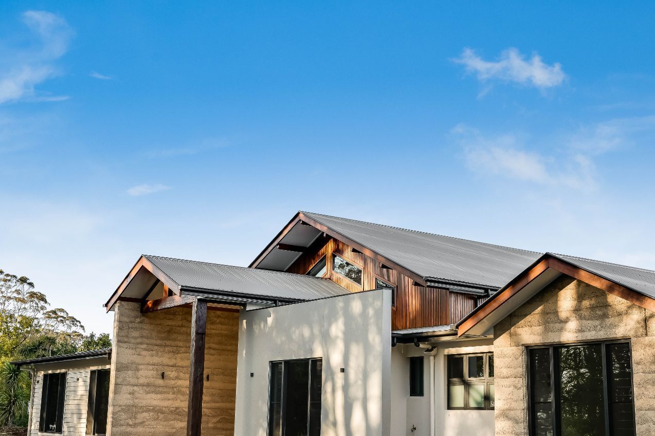 A Large House With a Wooden Roof and a Blue Sky in the Background — Windamere Homes in Highfields, QLD