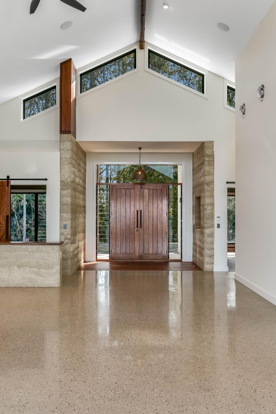 An Empty Room With a Ceiling Fan and a Refrigerator — Windamere Homes in Highfields, QLD