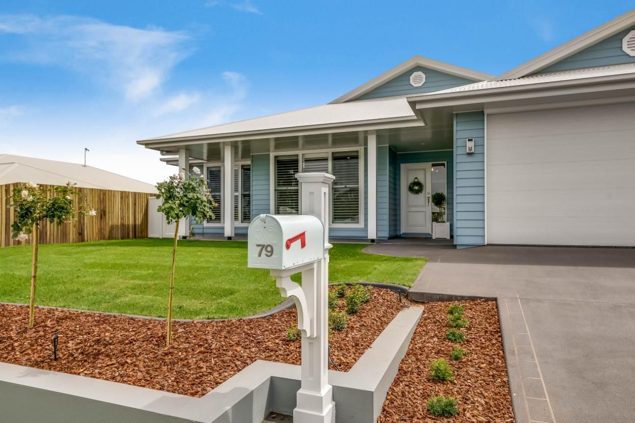 A Blue House With a White Mailbox in Front of It — Windamere Homes in Highfields, QLD