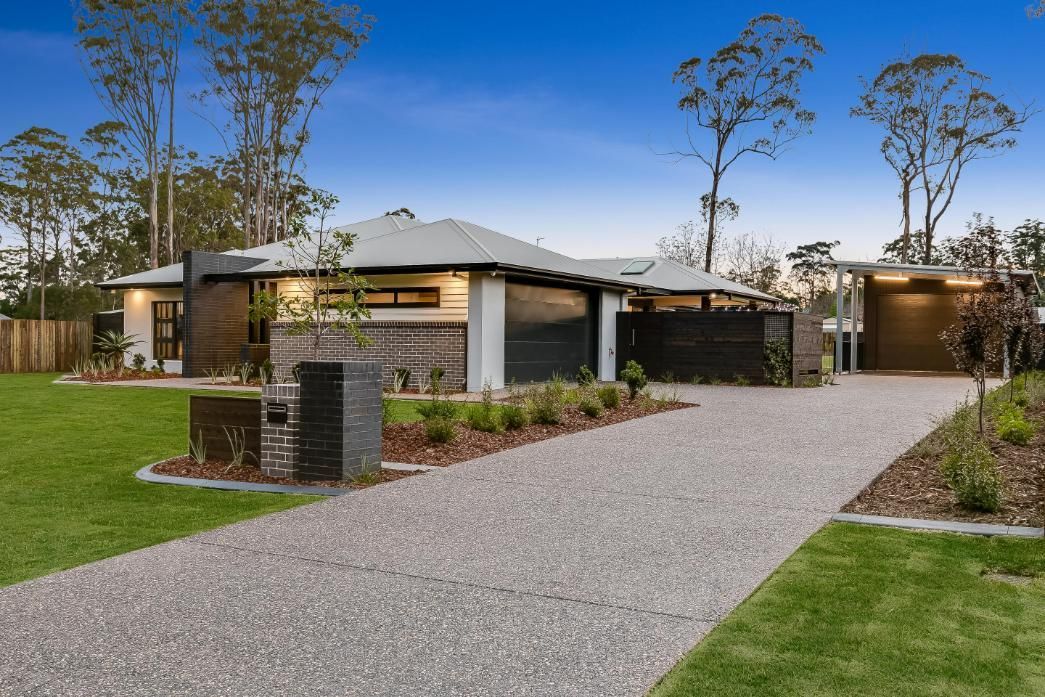 A Modern House With a Gravel Driveway — Windamere Homes in Highfields, QLD