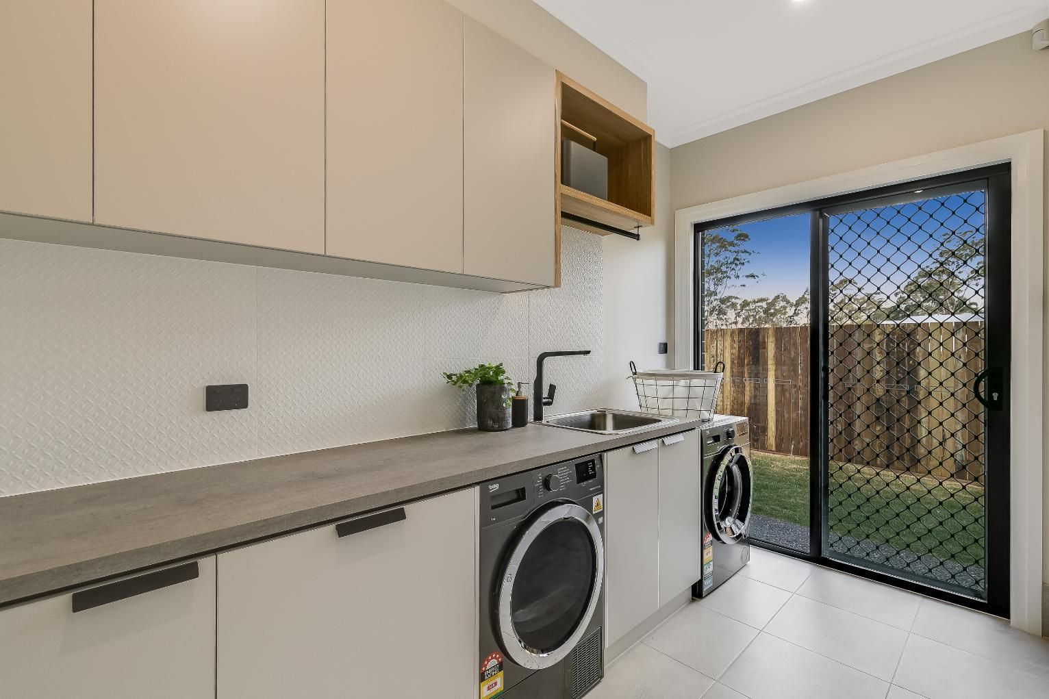 A Laundry Room With a Washer and Dryer — Windamere Homes in Highfields, QLD