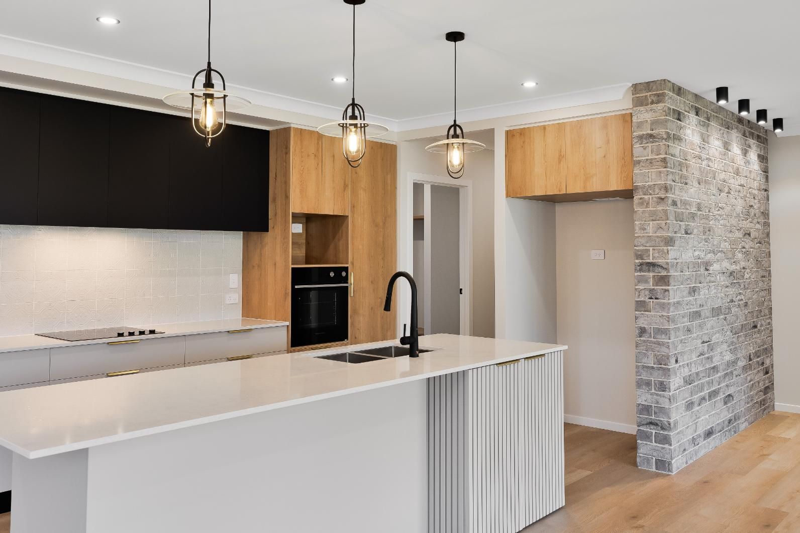 A Kitchen With an Island and Wall — Windamere Homes in Highfields, QLD