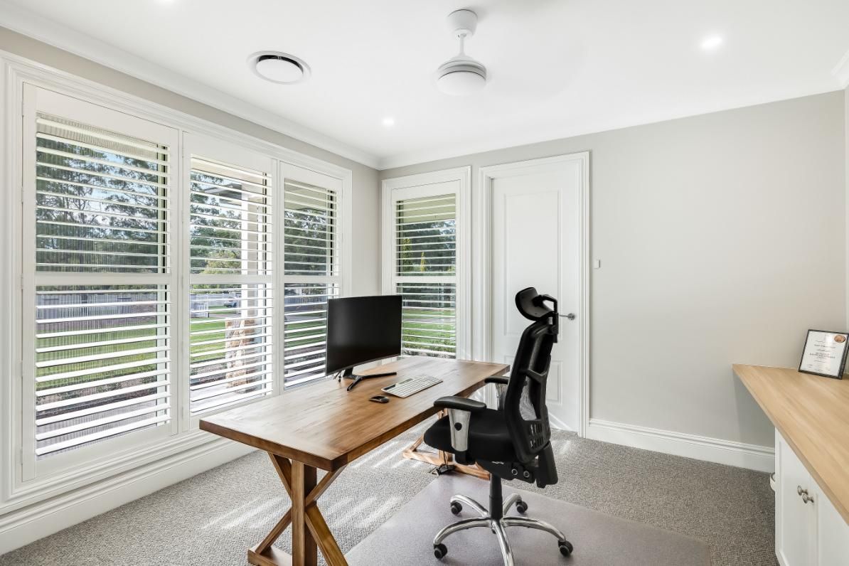 A Home Office With a Desk , Chair and Computer — Windamere Homes in Highfields, QLD