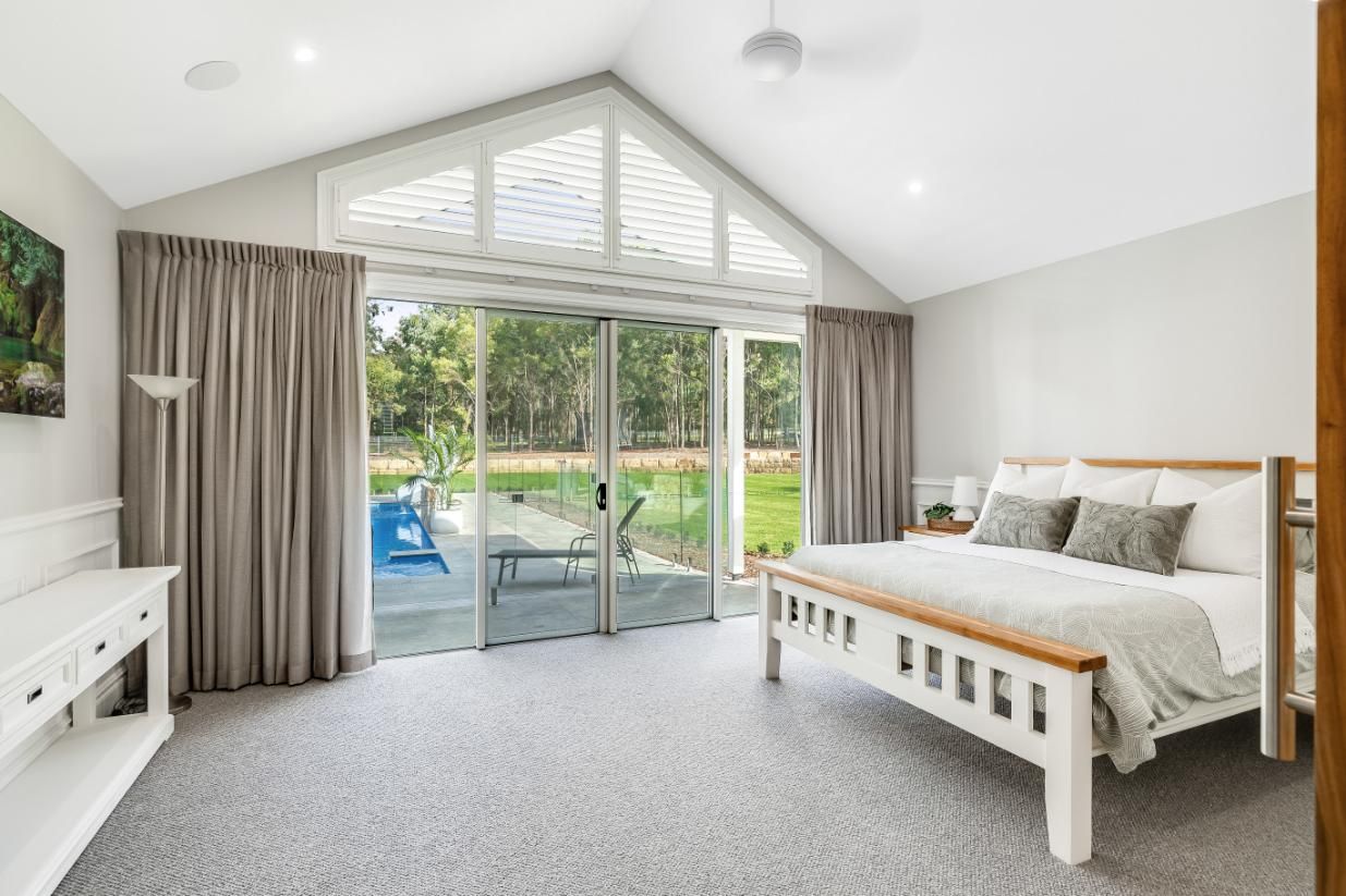A Bedroom With a King Size Bed — Windamere Homes in Highfields, QLD