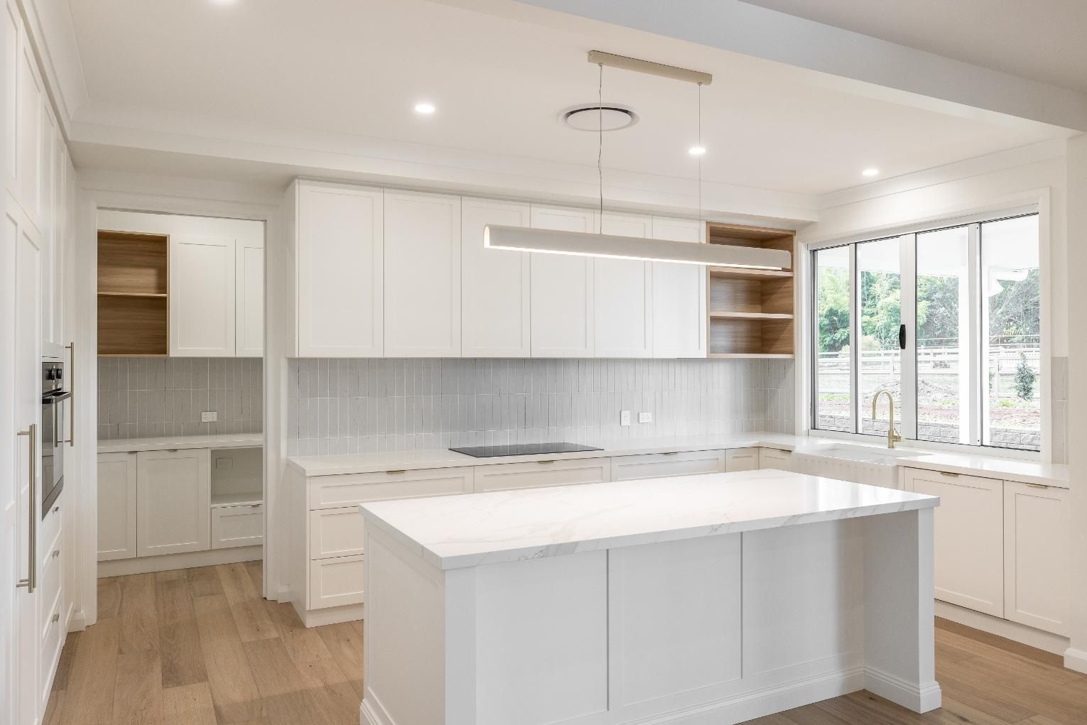 A Kitchen With Cabinet and an Island — Windamere Homes in Highfields, QLD