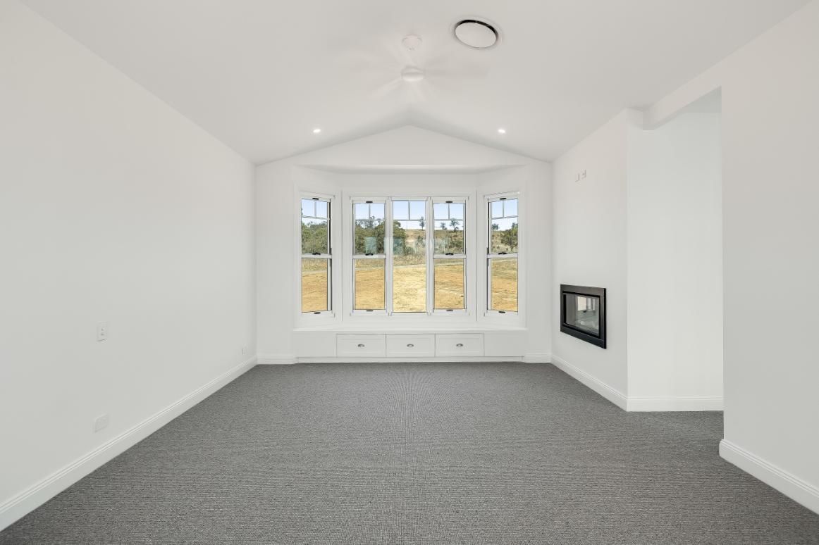 A Living Room With a Large Window — Windamere Homes in Highfields, QLD