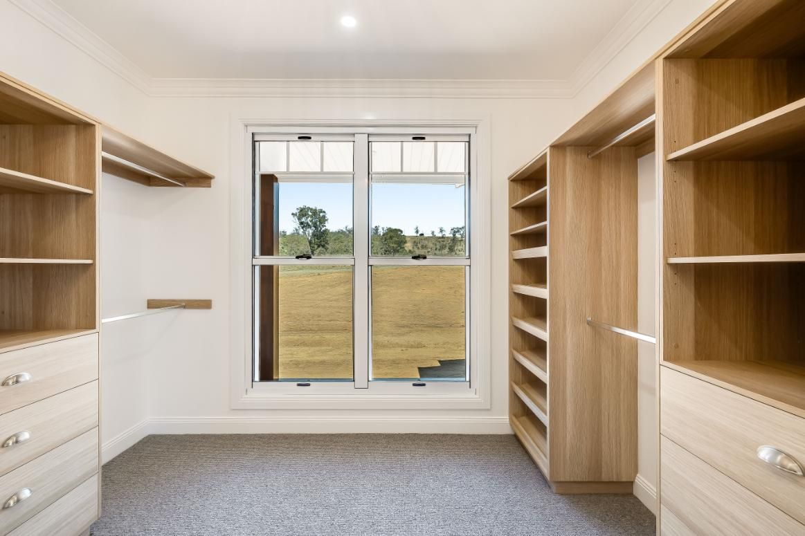 A Walk in Closet With Lots of Shelves — Windamere Homes in Highfields, QLD
