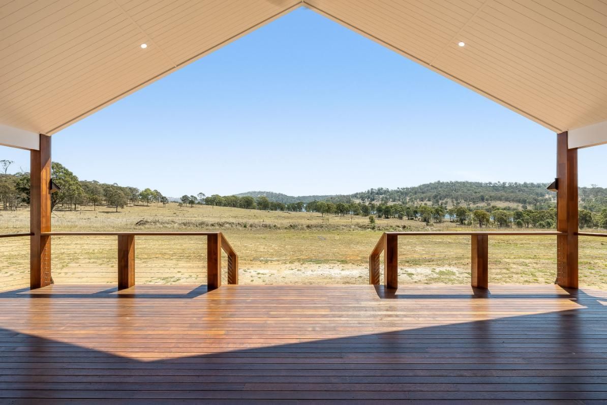 A Wooden Deck With a View of a Field — Windamere Homes in Highfields, QLD