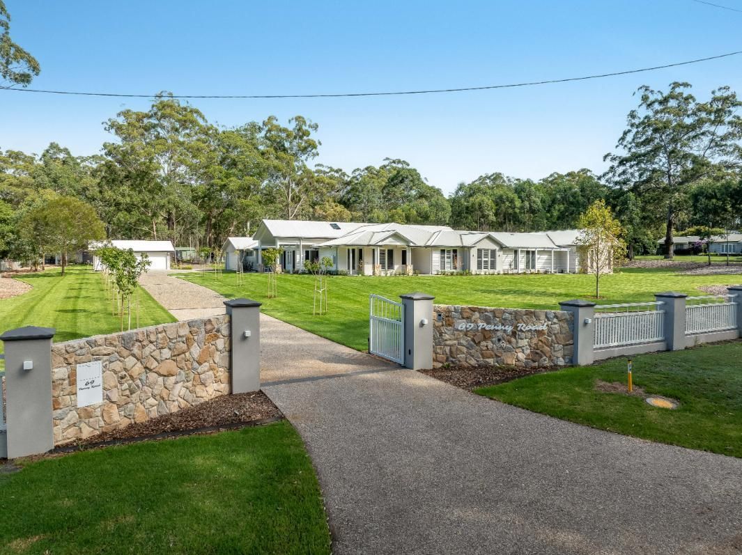 A Large House With a Wall and Driveway — Windamere Homes in Highfields, QLD
