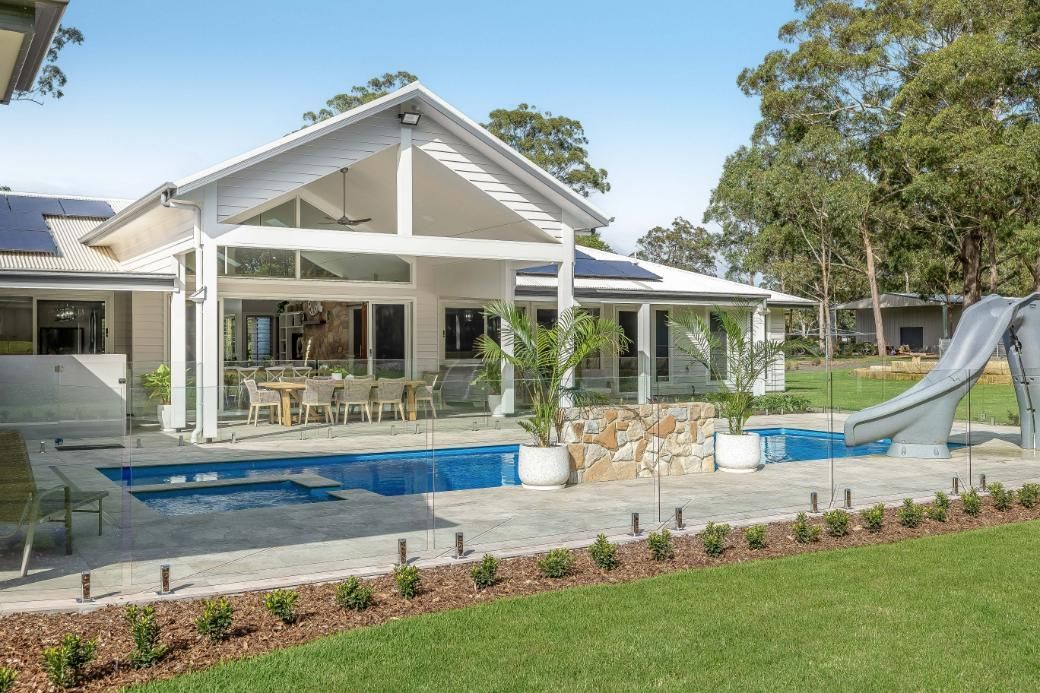 A Large House With a Swimming Pool and a Slide in the Backyard — Windamere Homes in Highfields, QLD