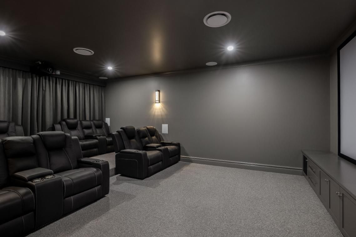 A Home Theater With a Couch and a Large Screen — Windamere Homes in Highfields, QLD