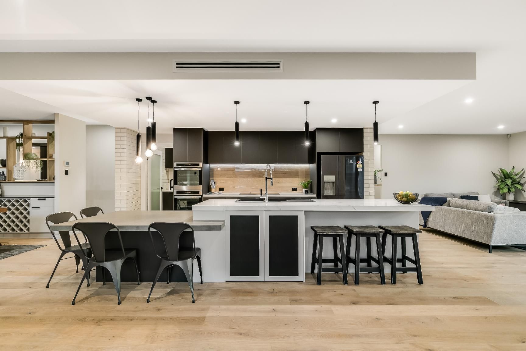 A Kitchen With a Large Island and a Table — Windamere Homes in Highfields, QLD