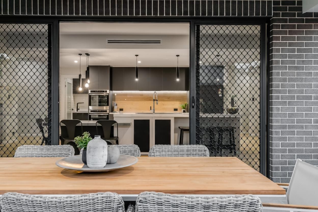 A Wooden Table and Chairs — Windamere Homes in Highfields, QLD