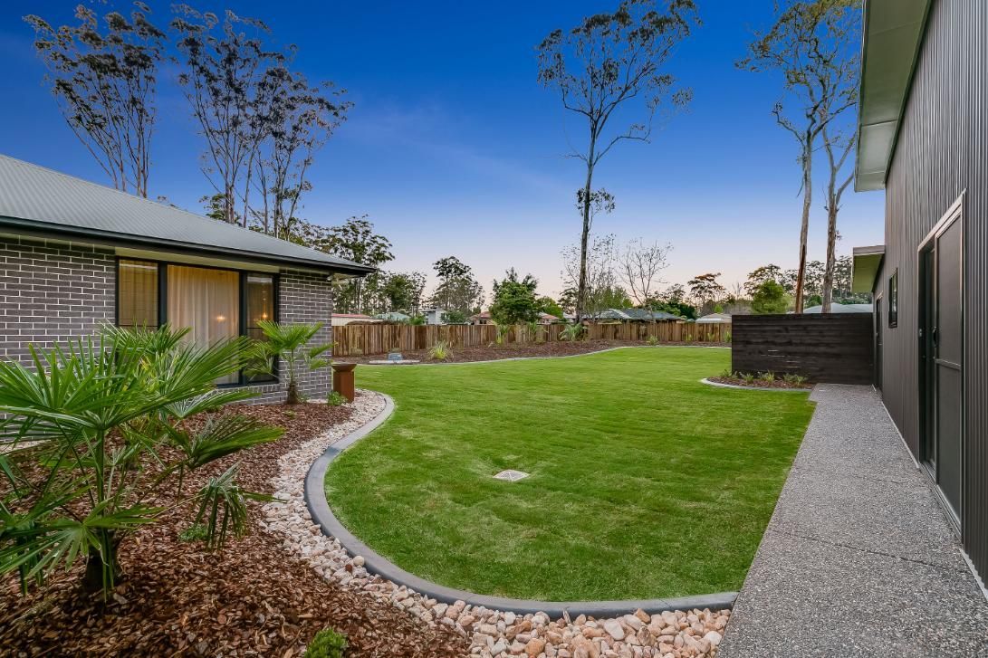 A House With a Large Lawn and a Walkway — Windamere Homes in Highfields, QLD