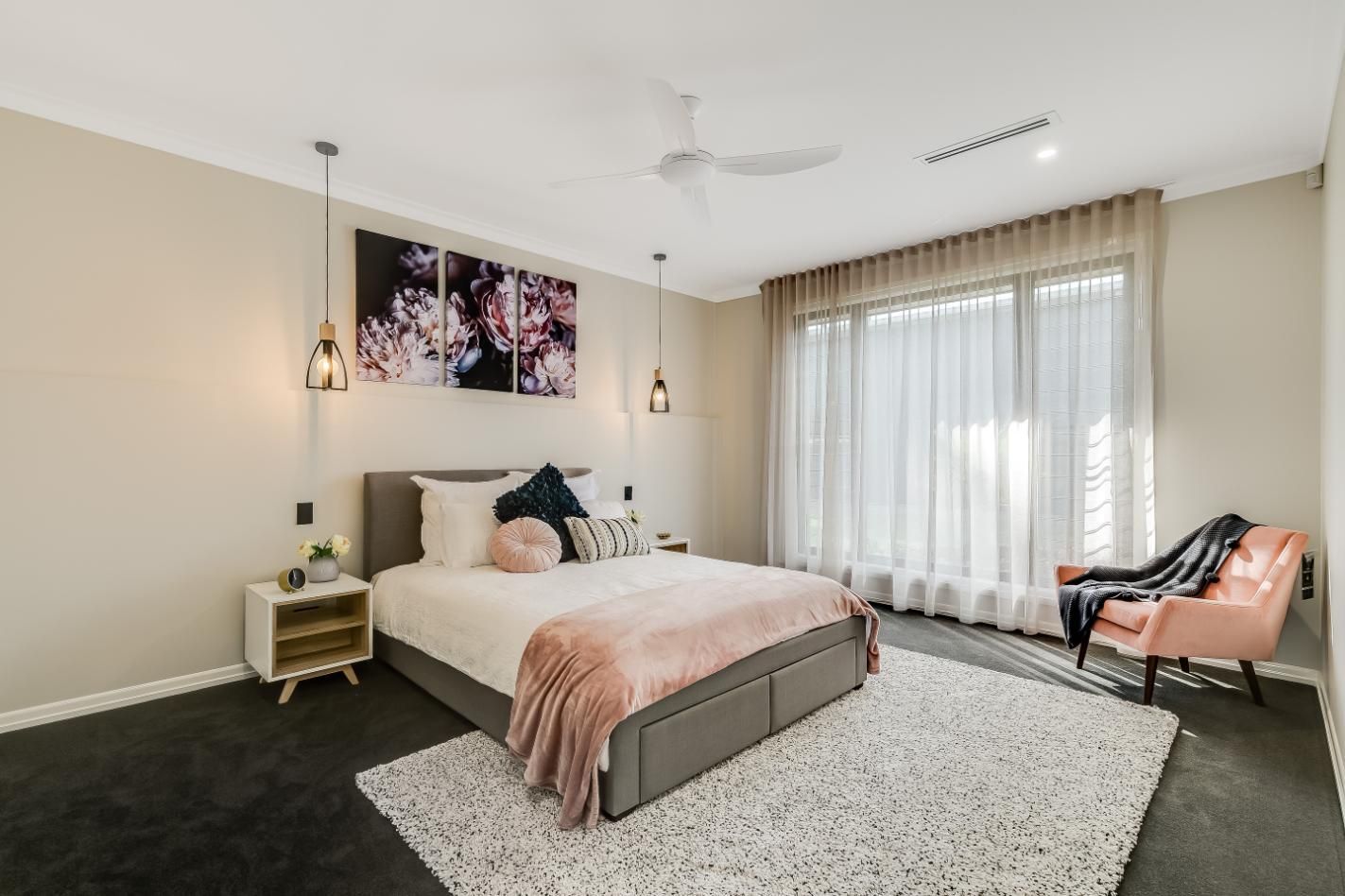 A Bedroom With a Large Bed and a Chair — Windamere Homes in Highfields, QLD