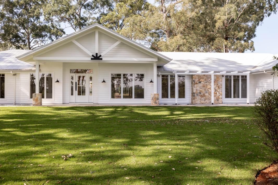 A Large White House With a Large Lawn in Front of It — Windamere Homes in Highfields, QLD