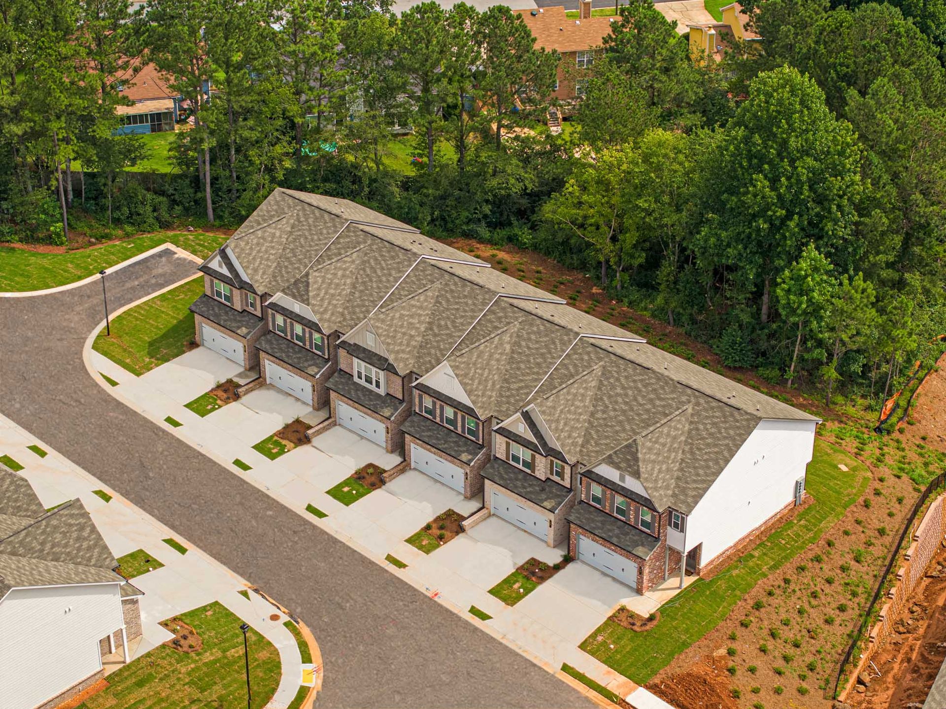 An aerial view of a row of houses with garages in a residential area at Collins Place.