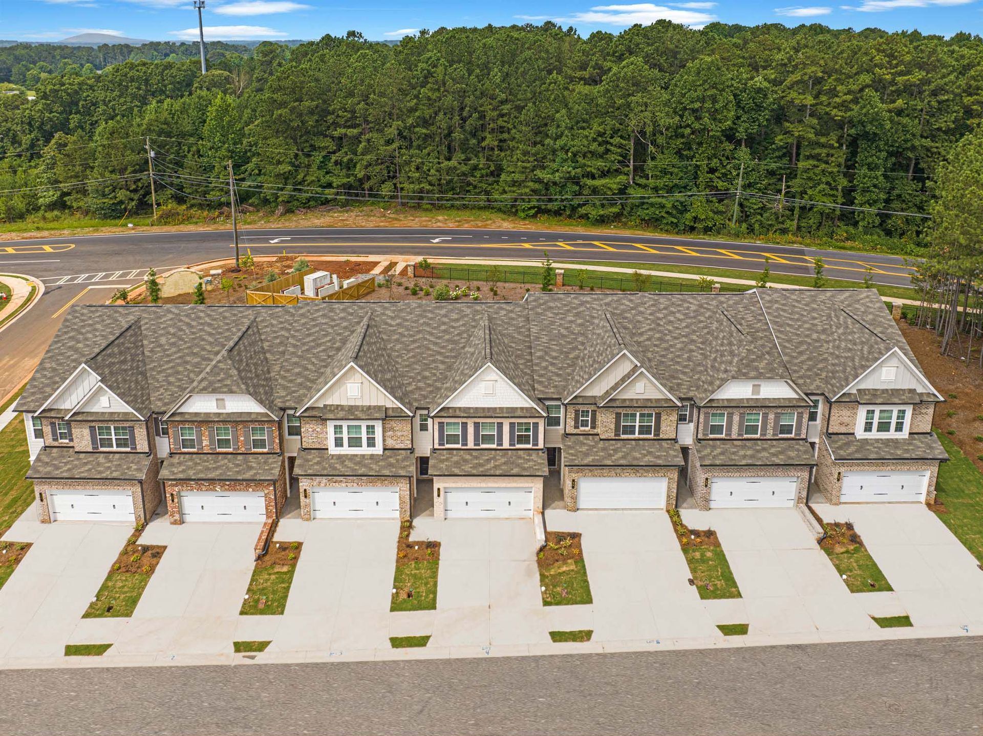 An aerial view of a row of houses next to a road at Collins Place.
