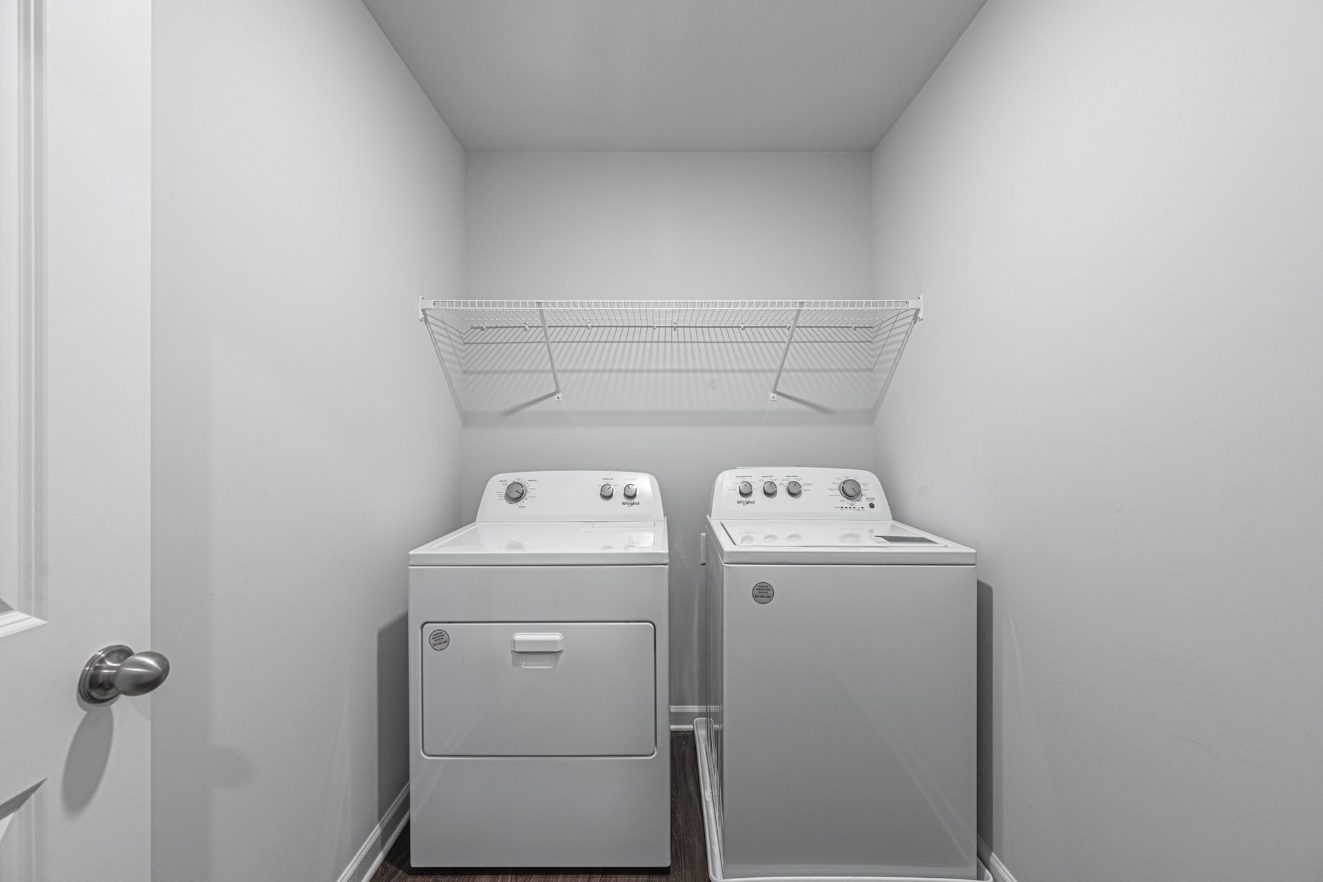 A laundry room with a washer and dryer in it at Collins Place.