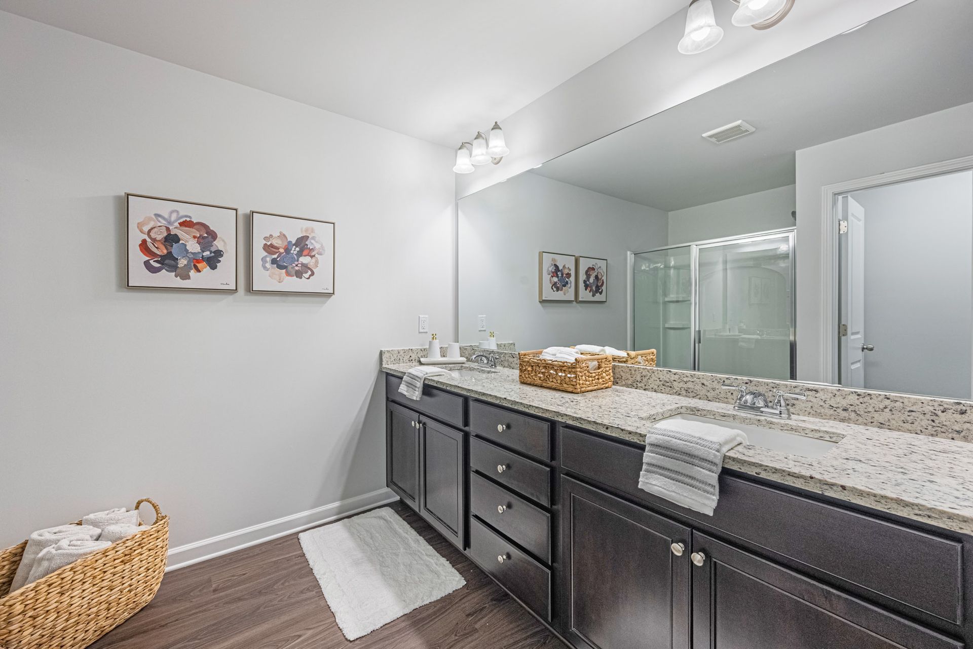 A bathroom with two sinks and a large mirror at Collins Place.