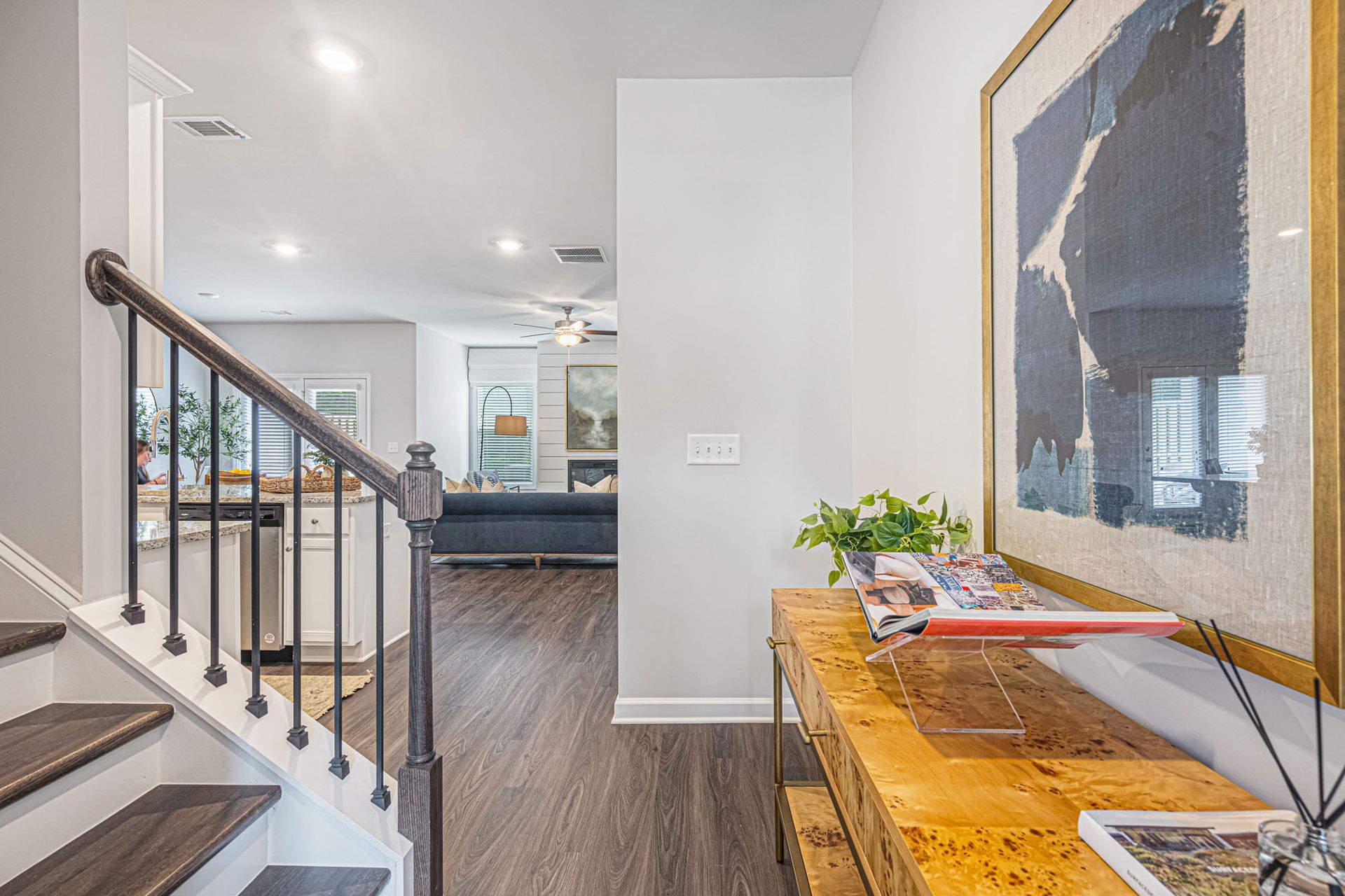 A hallway with stairs leading up to the second floor of a house at Collins Place.