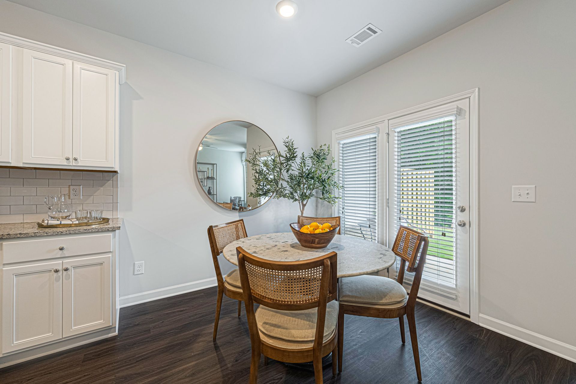 A dining room with a table and chairs and a sliding glass door at Collins Place.